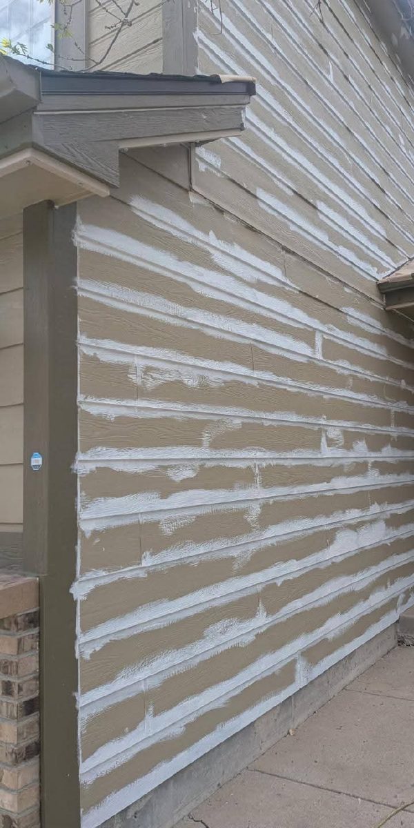 Siding patched and spot-primed before painting