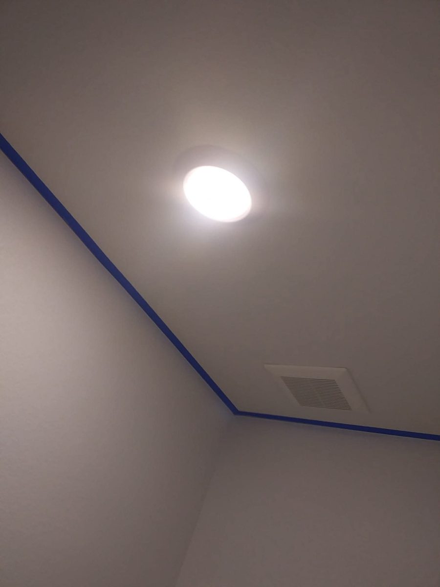 Crisp painted cut line where wall meets ceiling, with painter's tape, by Rock's Finest Finishes