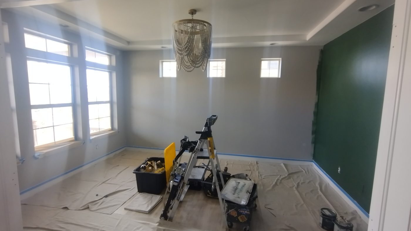 Dining room with drop cloths covering the floor before painting, by Rock's Finest Finishes