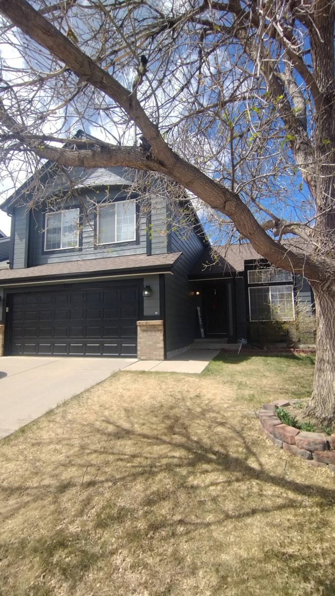 Finished navy two-story home exterior by Rock's Finest Finishes