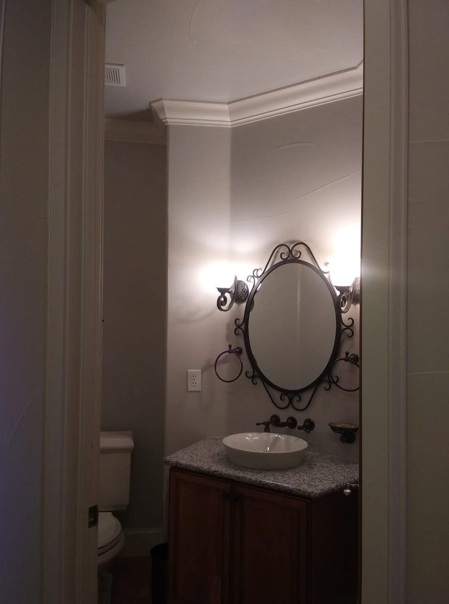 Finished powder room with crown molding by Rock's Finest Finishes